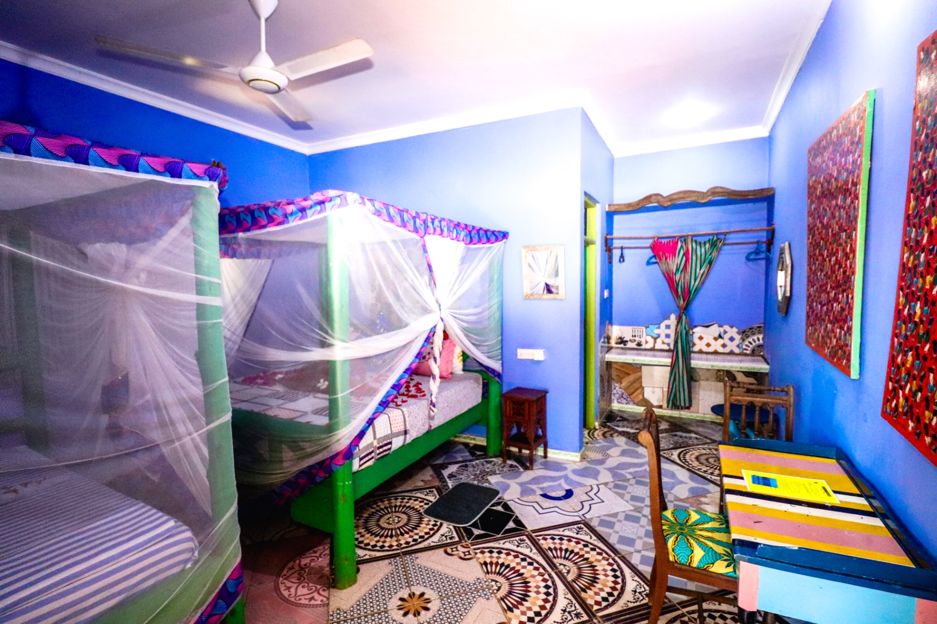 Blue room with canopy beds and African textiles