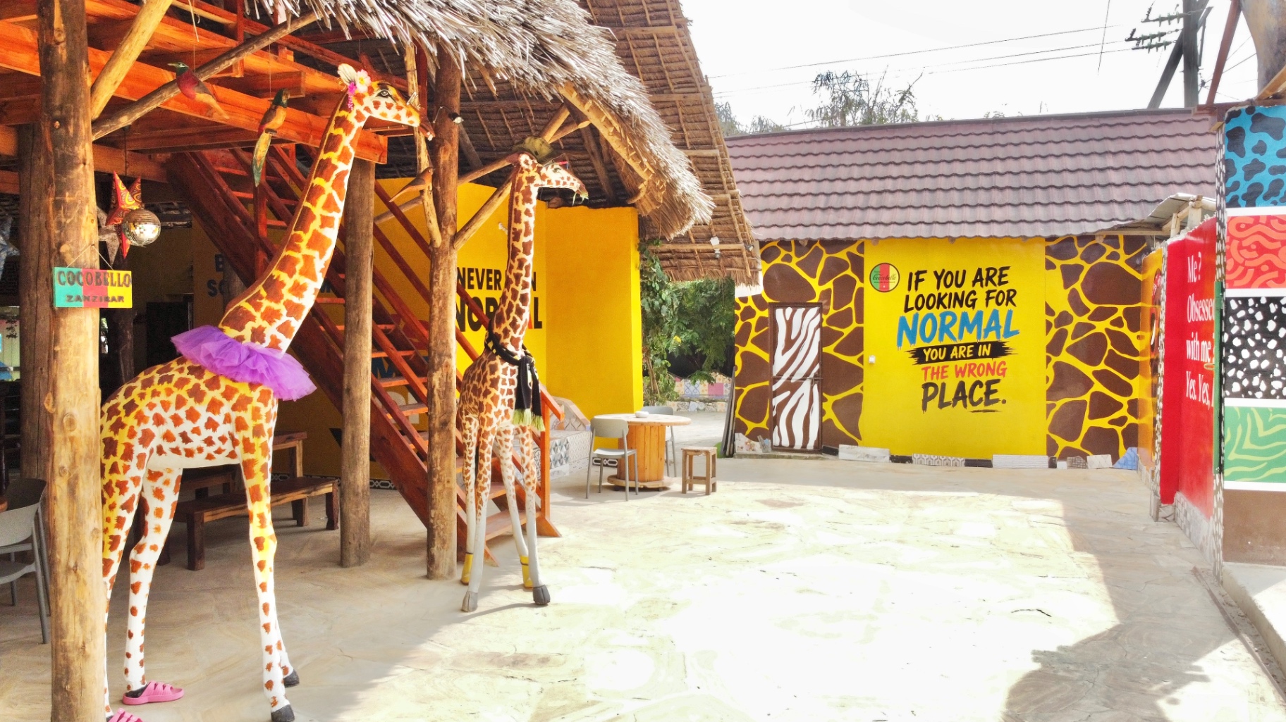 Giraffe statues under thatched roof at Coccobello courtyard