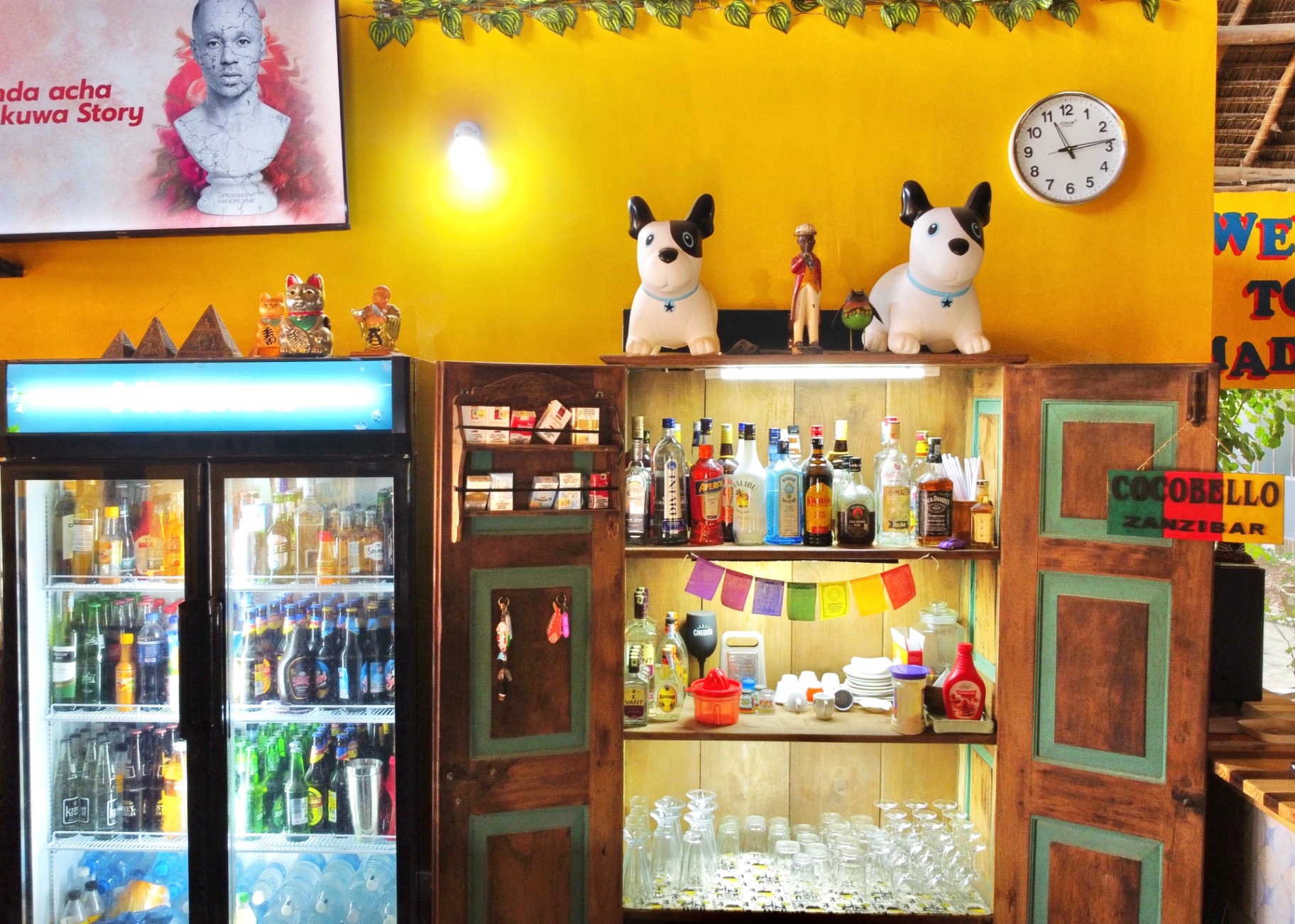 Coccobello bar with vintage bottles and playful dog figurines